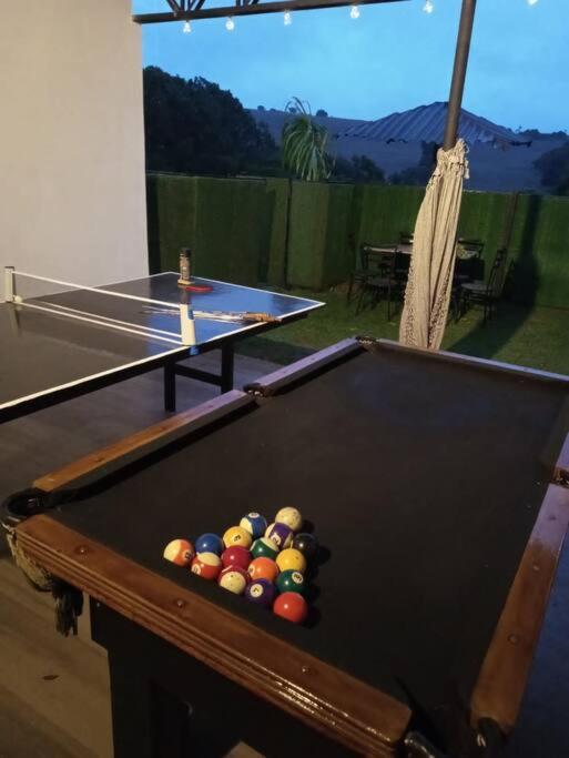 a pool table with balls in the middle of it at casa com bela vista em itatiba in Tijuco Prêto