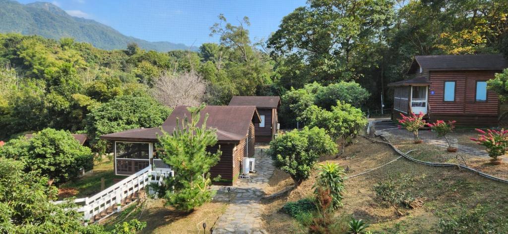an aerial view of a house with trees and mountains at Ji Ji Farm Homestay in Jiji