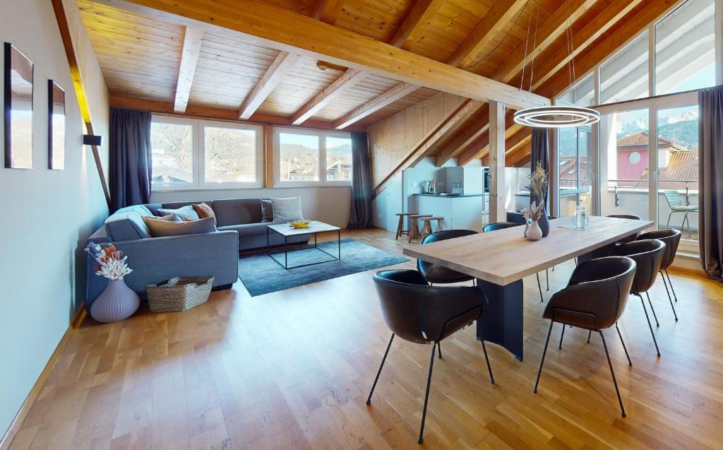 a dining room and living room with a table and chairs at WeitsichtLodge in Garmisch-Partenkirchen