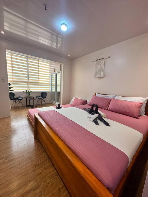 a large bedroom with a large bed with a stuffed animal on it at Yllib Transient Condo in Baguio
