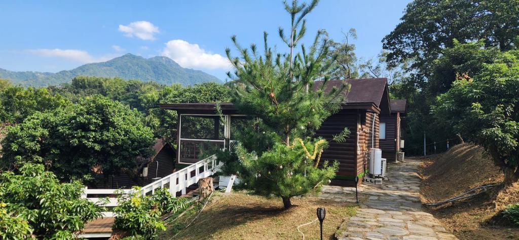a small house with a tree in front of it at Ji Ji Farm Homestay in Jiji