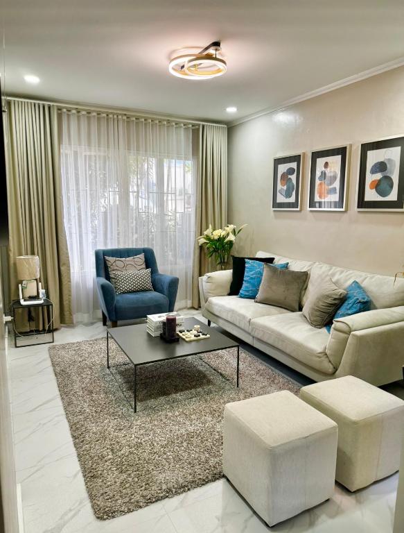 a living room with a couch and a table at Bonel Townhouse Tagaytay in Alfonso
