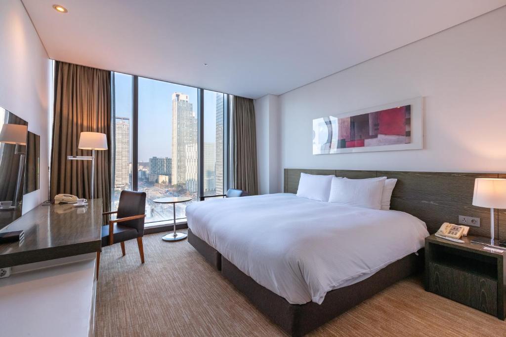 Postel nebo postele na pokoji v ubytování Orakai Songdo Park Hotel
