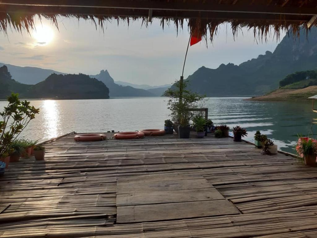 a wooden dock with a view of a lake at Mường Trai Homestay in Sơn La