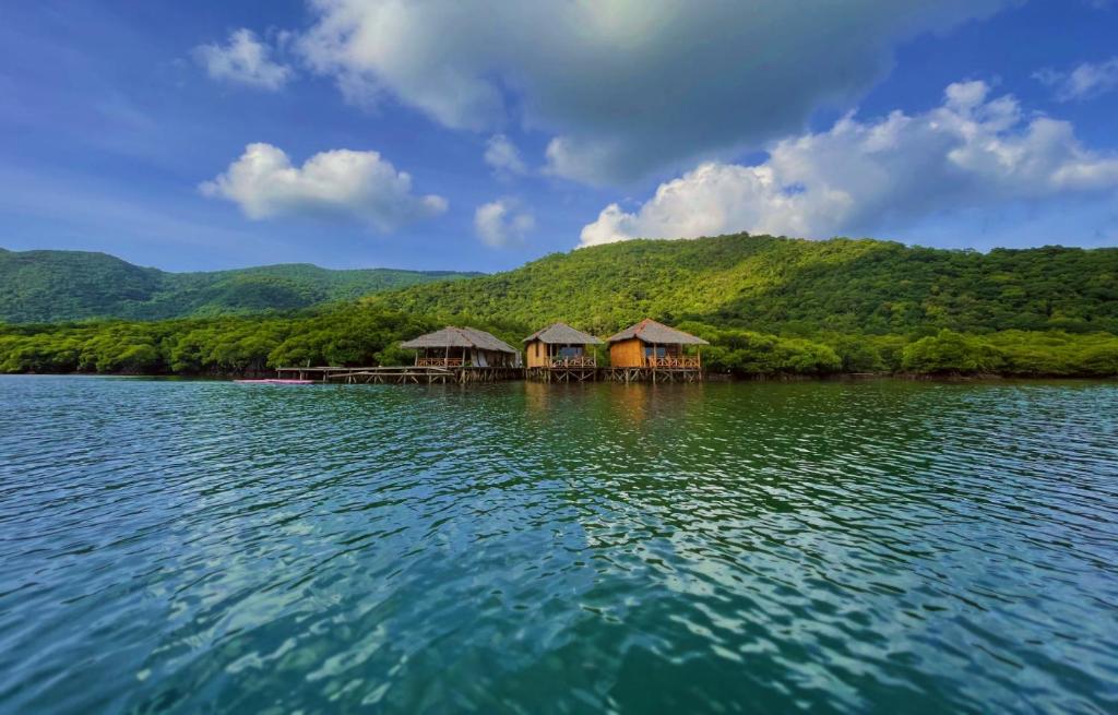 a group of huts in the middle of a body of water at Floating Paradise in Karimunjawa