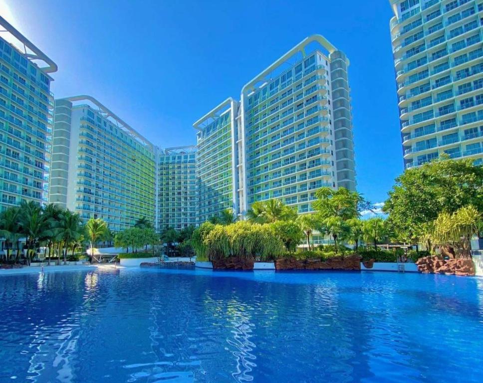 a large swimming pool in front of two tall buildings at SM Bicutan Condominium in Manila