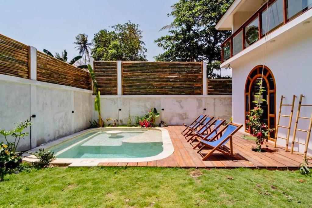 un patio avec des chaises et une piscine dans l'établissement Kerasia 2 BR Villa With Private Pool NE61, à Gili Air