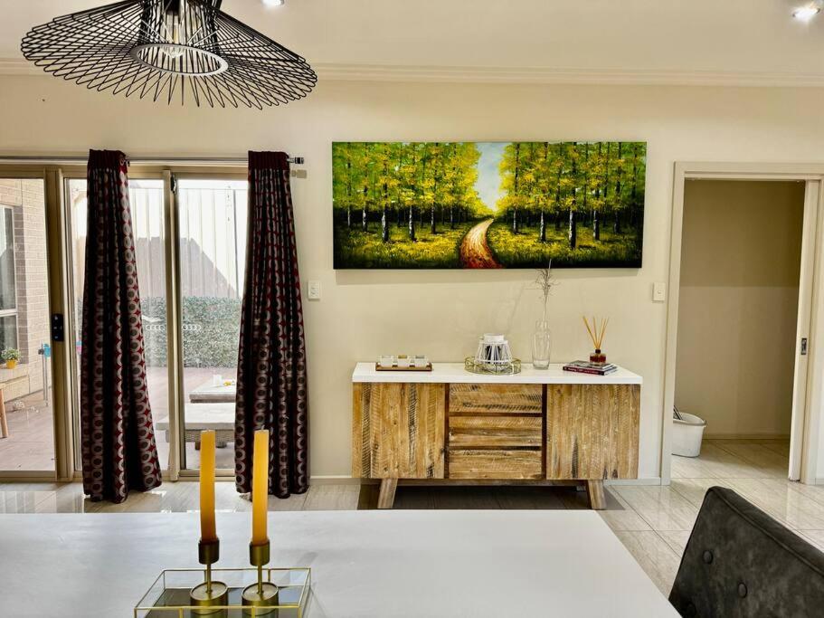 a living room with a painting on the wall at Morden Elegant 4 Bedroom House in Broadview