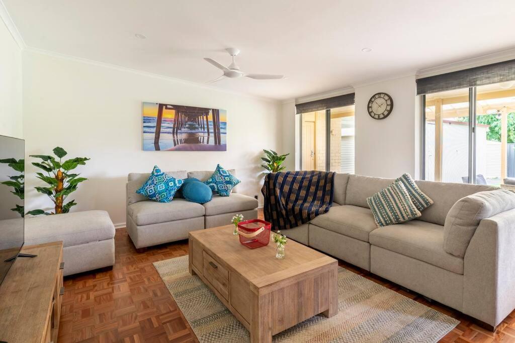 a living room with two couches and a coffee table at Birkinshaw Villa ( 3 Bedroom with Parkings ) in Broadview