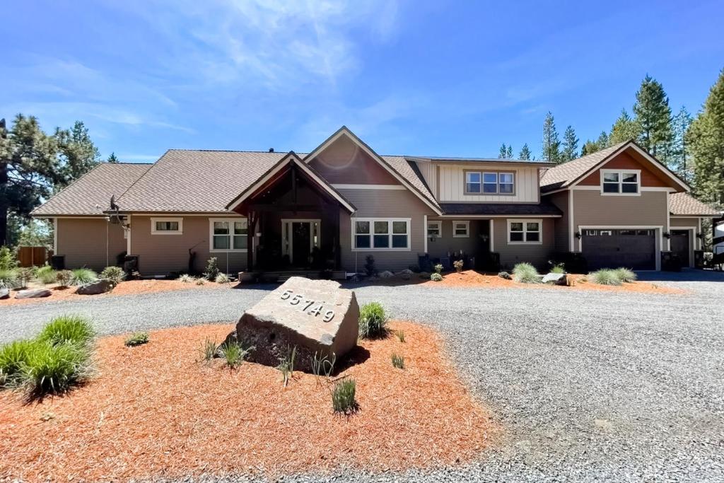 a house with a driveway with a sign on it at Deschutes Daydream in Bend