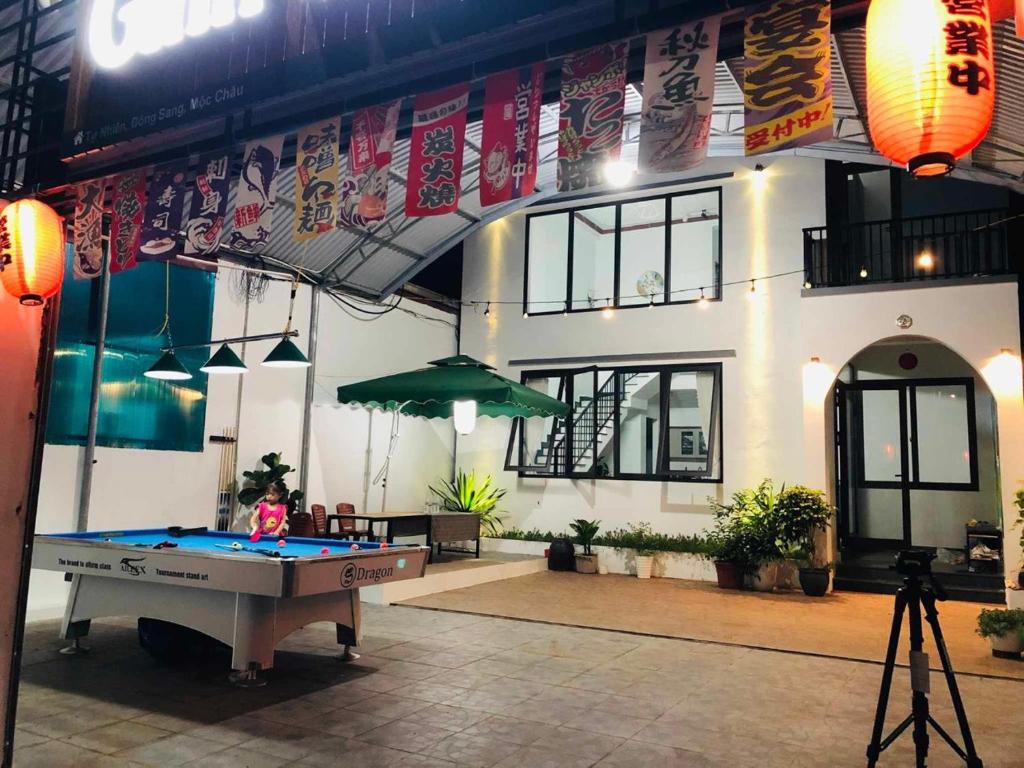a pool table in front of a building at Villa GinnHouse Mộc Châu 1 in Mộc Châu