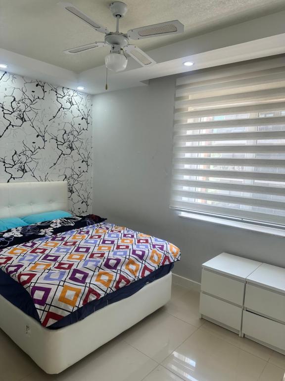a bedroom with a bed and a ceiling fan at confort residance in Antalya