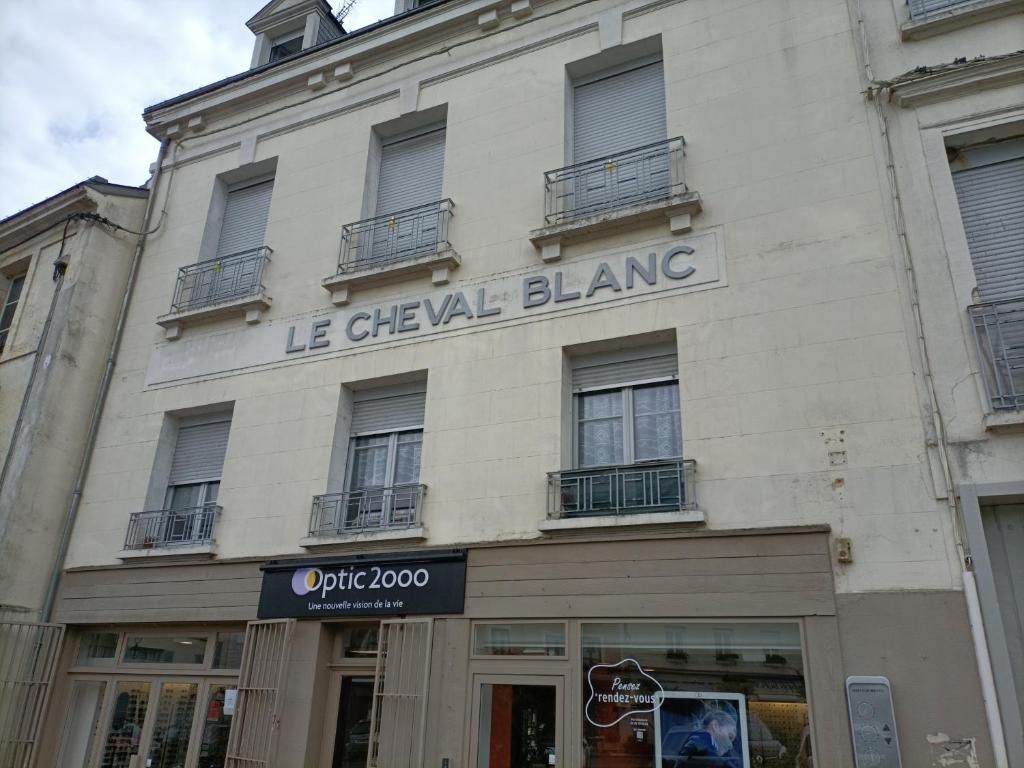 un edificio con un cartello che legge le cheval blanc di Le Cheval Blanc La Chartre sur le Loir a La Chartre-sur-le-Loir