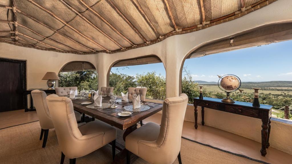馬賽馬拉的住宿－Olarro Plains，一间带桌椅和窗户的用餐室