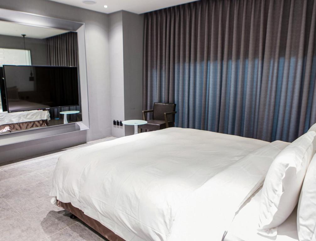 Postel nebo postele na pokoji v ubytování All-Ur Boutique Motel - Xinzhuang Branch