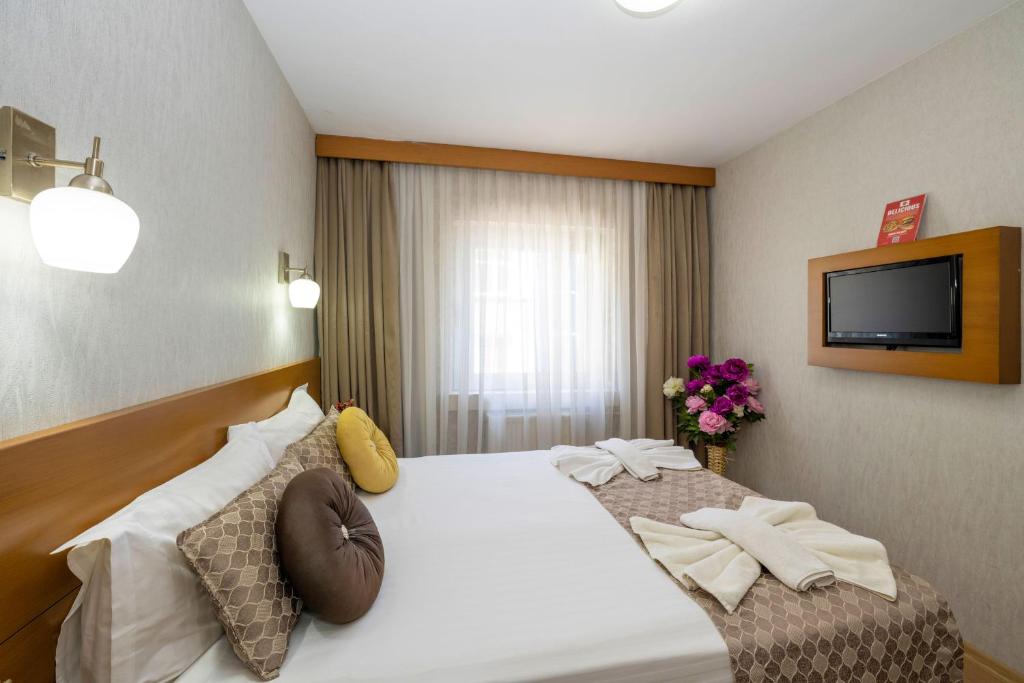Postel nebo postele na pokoji v ubytování Grand Ons Hotel