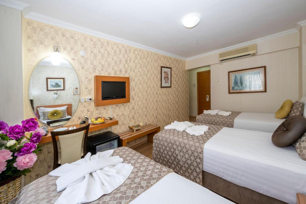 Postel nebo postele na pokoji v ubytování Grand Ons Hotel