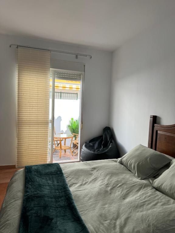 a bedroom with a bed and a view of a patio at Habitacion 801 in Estepona