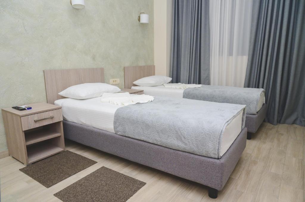 Postel nebo postele na pokoji v ubytování IPN ROOMs