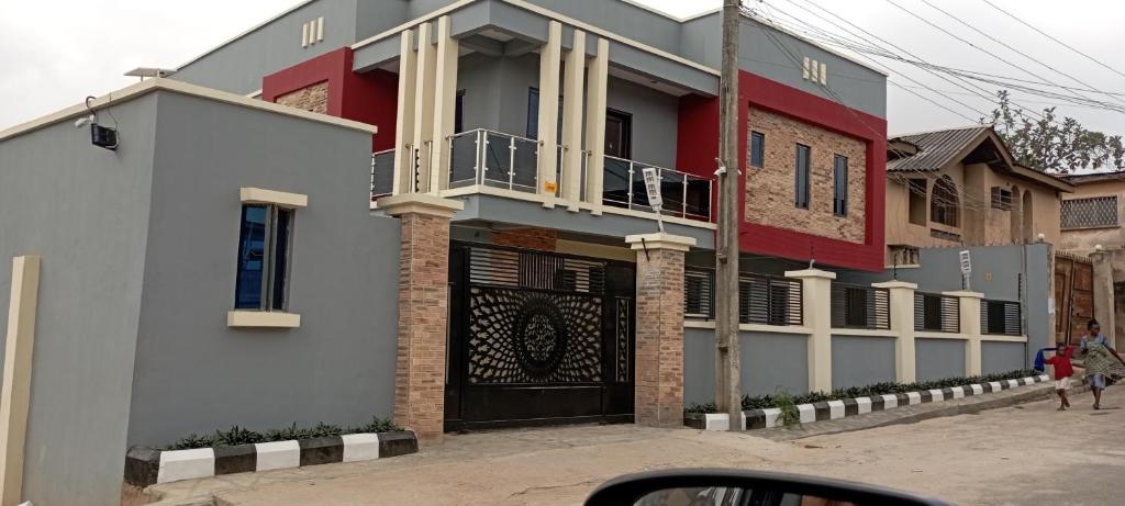 a house with a red and white building at WestMore Court a.k.a The Family House in Ibadan