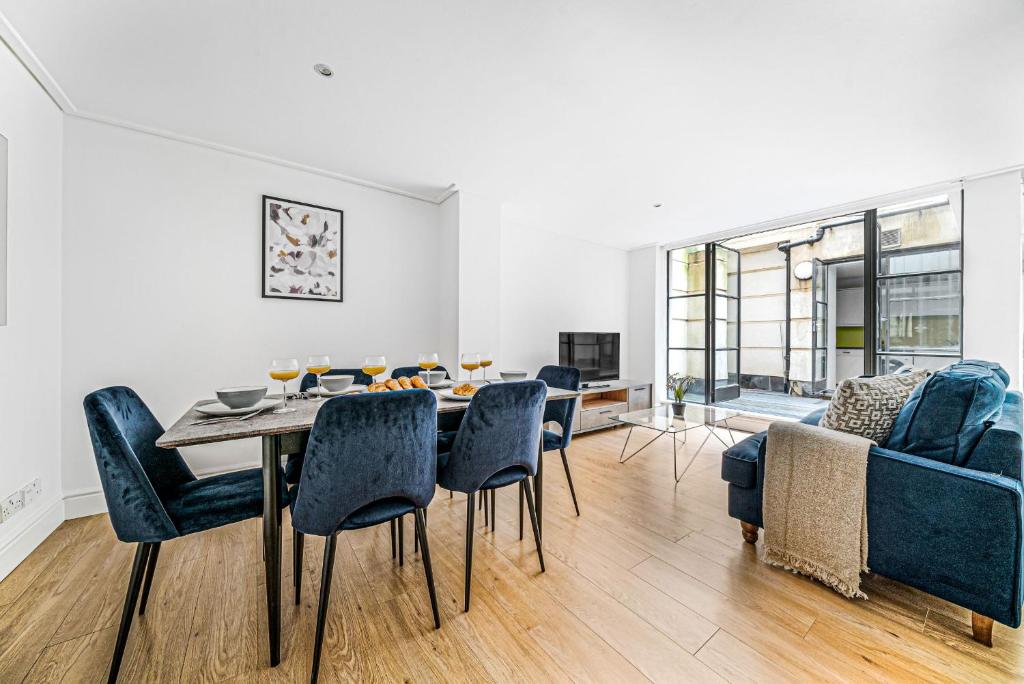 a dining room with a table and chairs at Heart of Holborn with Patio - CityApartmentStay in London