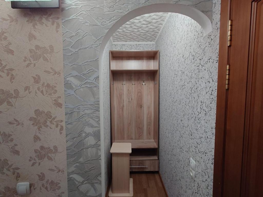 a hallway with a wooden cabinet in a room at Конгресс in Petropavlovsk