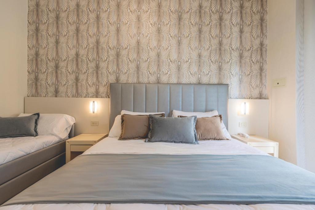 Postel nebo postele na pokoji v ubytování Hotel Athena