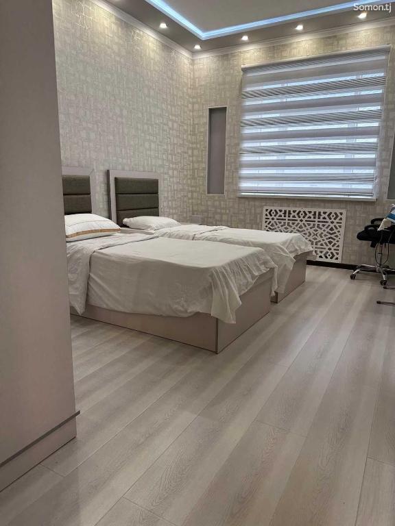a bedroom with a large bed and a large window at Apartment in Center Luxury in Dushanbe