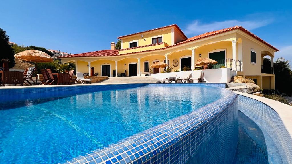 a large swimming pool in front of a house at Boutique Hotel Serena Vista in Pragança