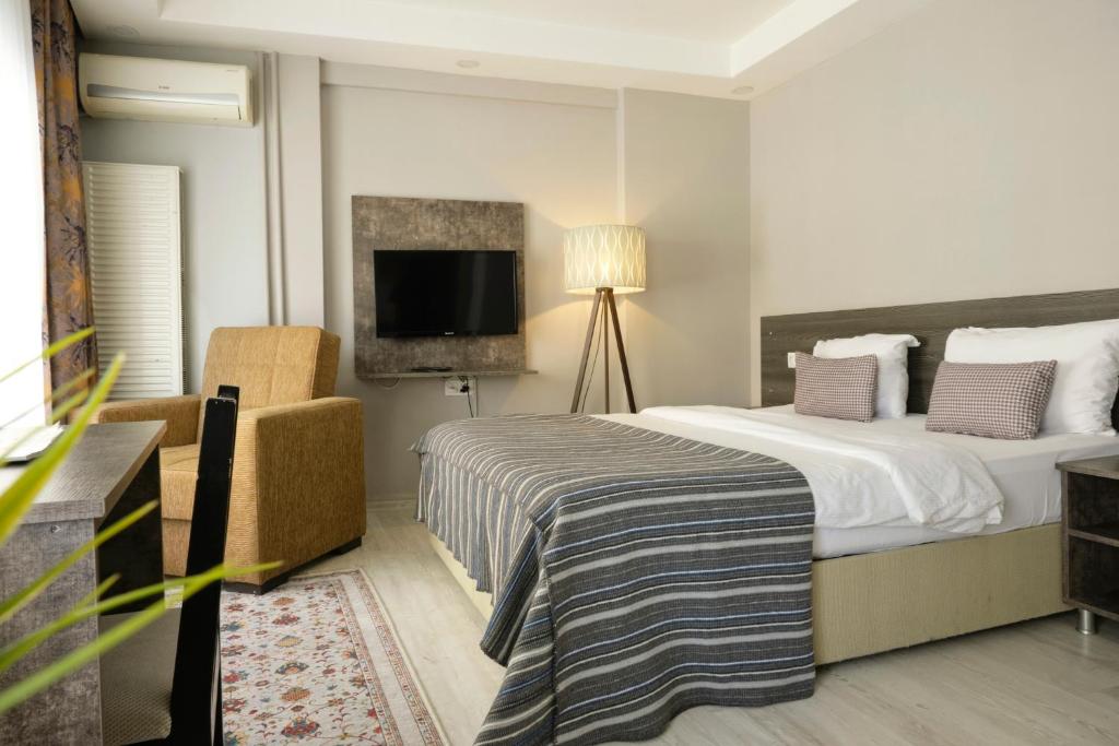 a hotel room with a bed and a television at The Breeze Hotel in Eskisehir