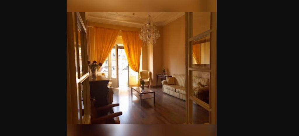 a living room with a couch and a chandelier at Room in Guest room - Viareggio Top Deco versilia in Viareggio