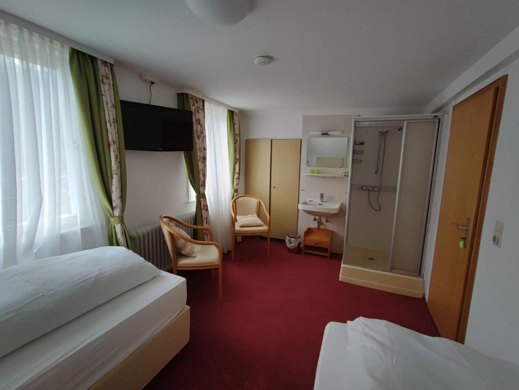 a hotel room with a bed and a bathroom at Room in Guest room - Pension Forelle - double room no1 in Forbach