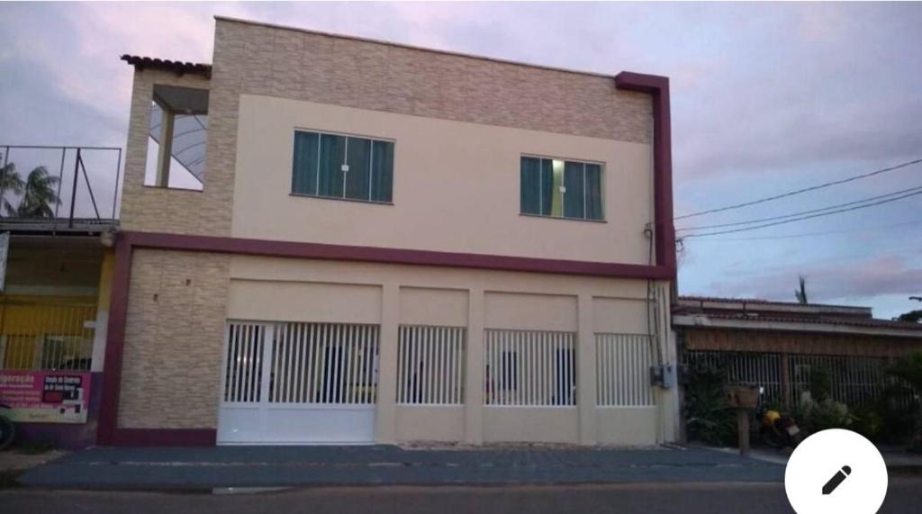 a building with two garage doors on the side of it at Loft privativo . in Macapá