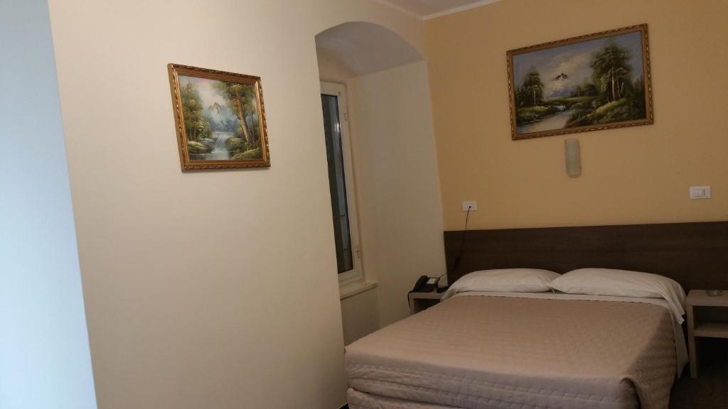 Postel nebo postele na pokoji v ubytování Hotel Tommaseo