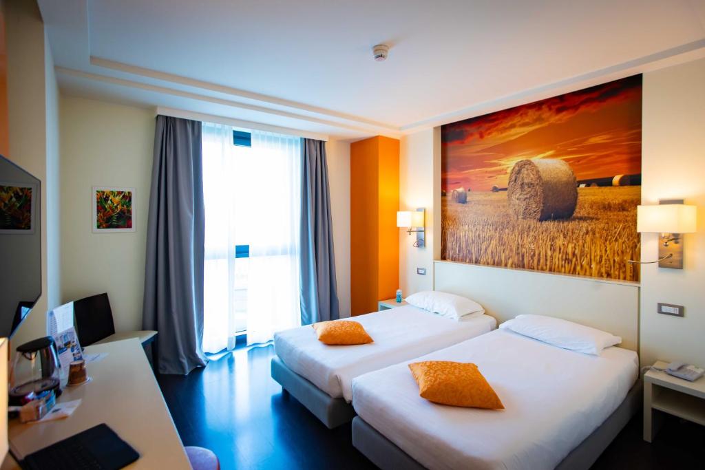 Postel nebo postele na pokoji v ubytování AN Hotel Milano Melegnano