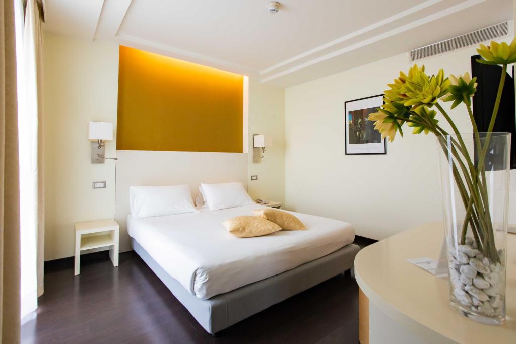 Postel nebo postele na pokoji v ubytování AN Hotel Milano Melegnano