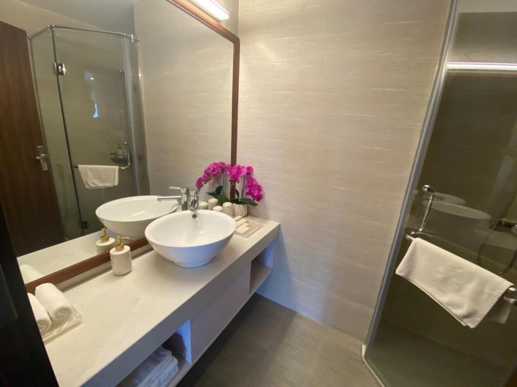 a bathroom with a sink and a shower at SweetHome Long Biên in Hanoi