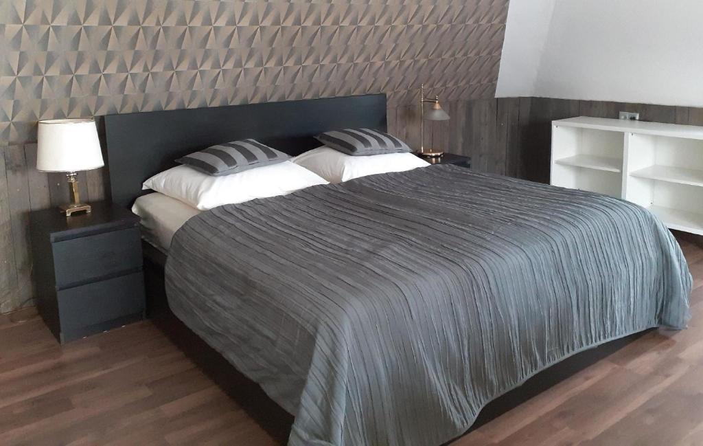 a bedroom with a large bed with two pillows at Apartment Sunline in Sulmin