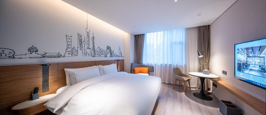 Postel nebo postele na pokoji v ubytování UrCove by HYATT Shanghai Jing'An