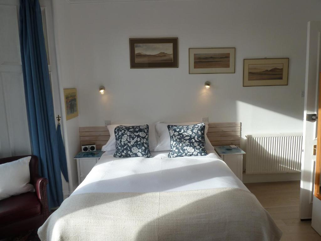 a bedroom with a large white bed with two pillows at Failte Bed & Breakfast in Oban