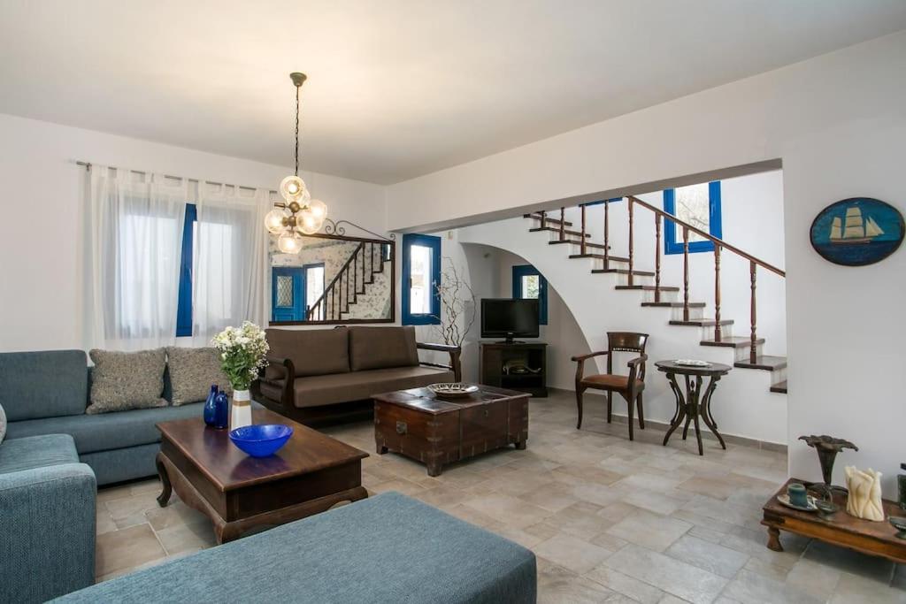 a living room with a couch and a table at Villa Kaya in Haraki