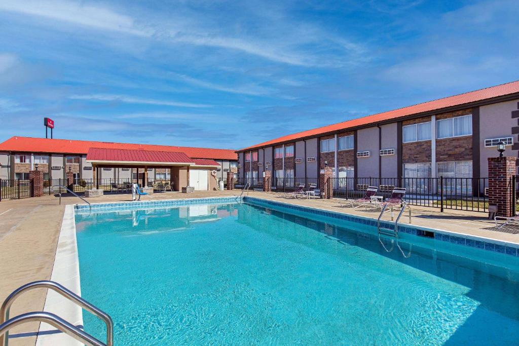 a large swimming pool in front of a building at Ramada by Wyndham Bowling Green in Bowling Green