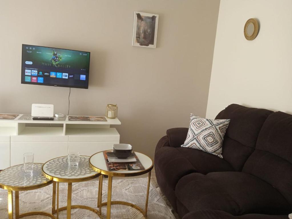 a living room with a couch and two tables at Viwak Homes in Mombasa