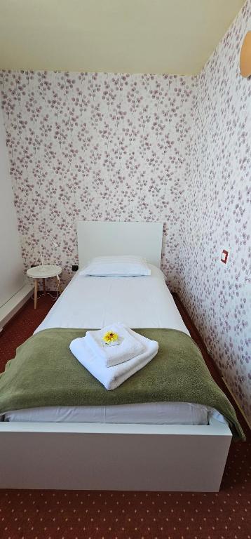 Postel nebo postele na pokoji v ubytování Hotel Olimp