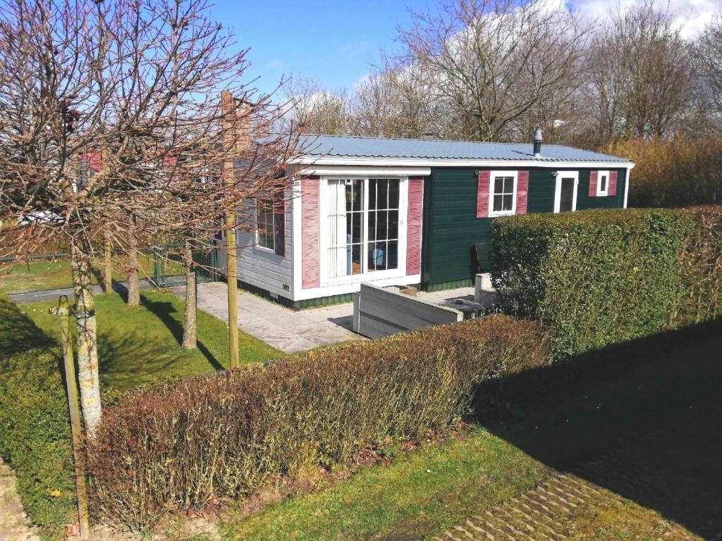 a small home with a red and green house at Gemütliches Chalet mit Terrasse in Baarland