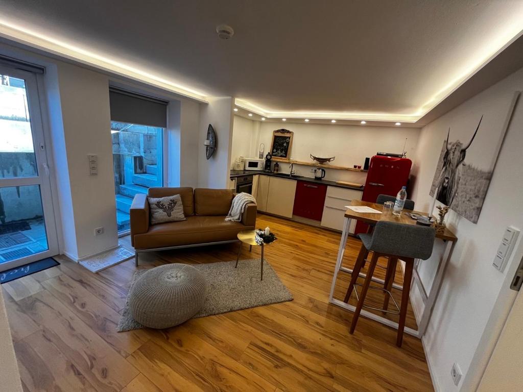 a living room with a couch and a kitchen at Anderswo Bad Aibling in Bad Aibling