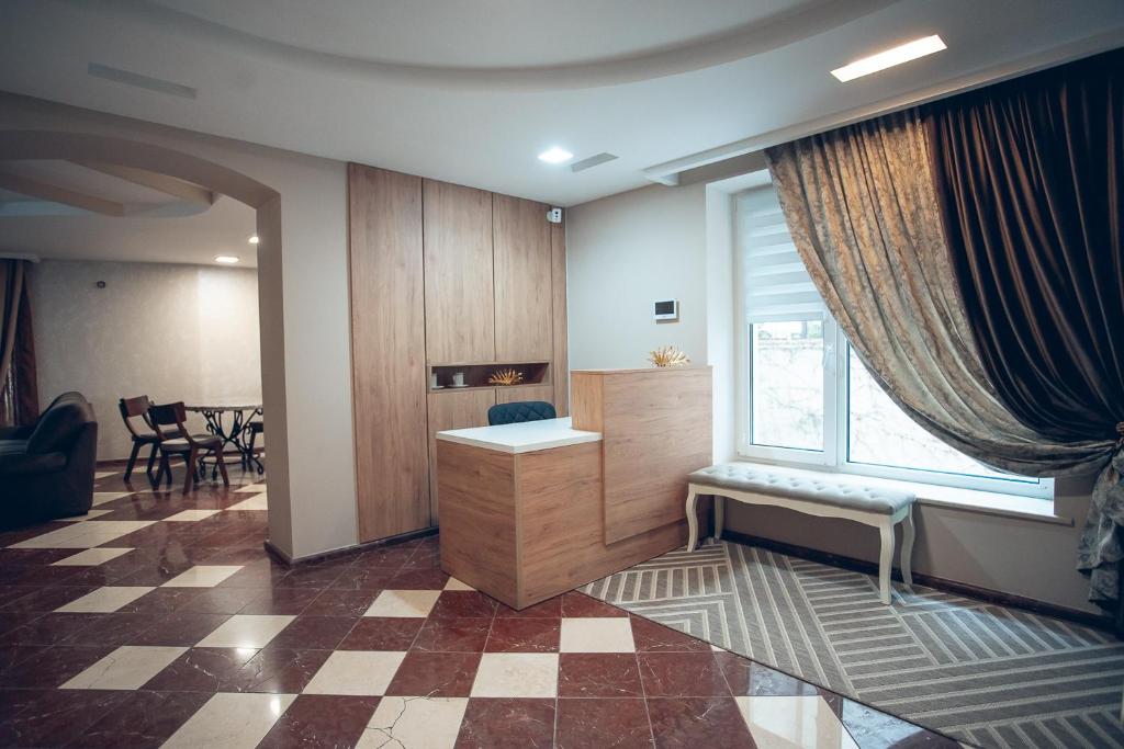 a living room with a desk and a window at Apart4you Hotel in Chişinău
