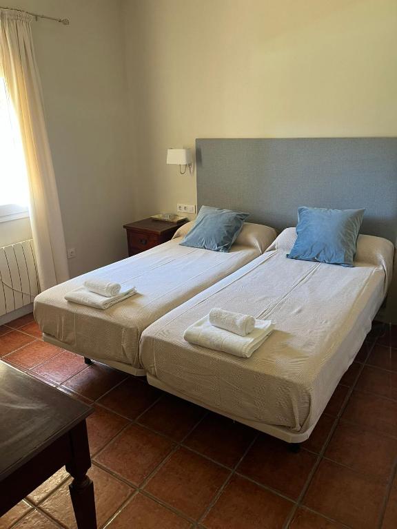 a bedroom with two beds with towels on them at Villa America in Roche