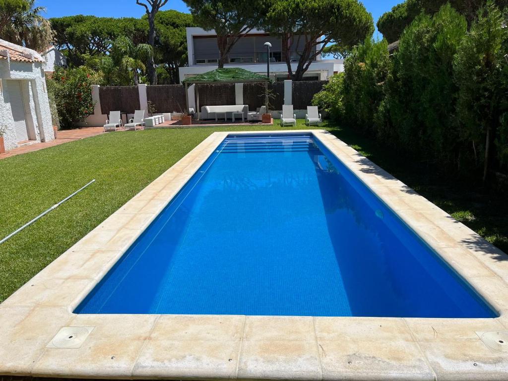 a swimming pool in the yard of a house at Villa America in Roche