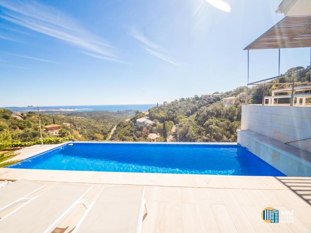 a swimming pool in a villa with a view at Villa Azalia in Castillo de Aro
